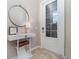 Welcoming foyer featuring a round mirror, accent table, and front door with glass panels letting in natural light at 14049 Black Beauty Dr # 721, Punta Gorda, FL 33955