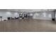 Spacious fitness area with wood-look floors, wall mounted equipment, weights, and mirrors at 14049 Black Beauty Dr # 721, Punta Gorda, FL 33955