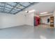 Spacious garage with modern gray epoxy flooring and painted white walls at 14049 Black Beauty Dr # 721, Punta Gorda, FL 33955