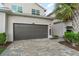 Attached garage with brick paved driveway and well manicured shrubs alongside property at 14049 Black Beauty Dr # 721, Punta Gorda, FL 33955