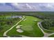 Expansive golf course aerial view with lush green fairways, sand traps, and scenic landscaping at 14049 Black Beauty Dr # 721, Punta Gorda, FL 33955