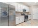Well-equipped kitchen featuring stainless steel appliances, granite countertops, and sleek white cabinetry at 14049 Black Beauty Dr # 721, Punta Gorda, FL 33955