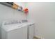 Convenient laundry room with a washing machine, dryer, and overhead wire shelving for storage at 14049 Black Beauty Dr # 721, Punta Gorda, FL 33955