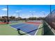 Outdoor pickleball courts with vibrant blue and red playing surfaces, surrounded by fencing at 14049 Black Beauty Dr # 721, Punta Gorda, FL 33955