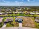 Scenic aerial view of a cozy blue home situated on a waterfront canal with beautifully landscaped surroundings at 149 Sportsman Rd, Rotonda West, FL 33947