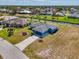 A beautiful blue single-Gathering home situated on a waterfront canal with lush landscaping and a private driveway at 149 Sportsman Rd, Rotonda West, FL 33947