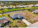 Scenic aerial view of a cozy blue home situated on a waterfront canal with beautifully landscaped surroundings at 149 Sportsman Rd, Rotonda West, FL 33947