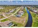 An aerial view of neighborhood homes with a scenic canal running through it at 149 Sportsman Rd, Rotonda West, FL 33947