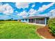 This home has a spacious backyard with a screened in porch and lush landscaping at 149 Sportsman Rd, Rotonda West, FL 33947
