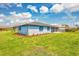 This house has a beautifully maintained lawn, colorful flower beds, and exterior shutters at 149 Sportsman Rd, Rotonda West, FL 33947