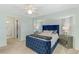 Comfortable bedroom featuring a blue velvet bed, plush carpeting, and en suite bathroom at 149 Sportsman Rd, Rotonda West, FL 33947