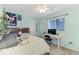 Charming bedroom with light blue walls, a ceiling fan, and a desk near the window at 149 Sportsman Rd, Rotonda West, FL 33947