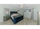 Comfortable bedroom featuring a blue velvet bed, plush carpeting, and two side tables at 149 Sportsman Rd, Rotonda West, FL 33947