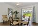 Dining area with glass table, seating for four, and view of the back yard at 149 Sportsman Rd, Rotonda West, FL 33947