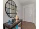 Inviting entryway features decorative mirror, stylish table, and a smooth transition to the hardwood flooring at 149 Sportsman Rd, Rotonda West, FL 33947