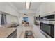 Galley kitchen has stainless appliances, granite countertops and connects to an office nook with natural light at 149 Sportsman Rd, Rotonda West, FL 33947