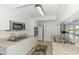 Updated kitchen featuring white cabinets, stainless appliances, granite countertops, and ceramic tile floors at 149 Sportsman Rd, Rotonda West, FL 33947