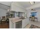 Updated kitchen featuring stainless steel dishwasher and granite countertops, connecting to dining and office areas at 149 Sportsman Rd, Rotonda West, FL 33947