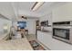 Galley kitchen has stainless appliances, granite countertops and connects to an office nook with natural light at 149 Sportsman Rd, Rotonda West, FL 33947