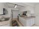 Updated kitchen featuring white cabinets, stainless appliances, granite countertops, and ceramic tile floors at 149 Sportsman Rd, Rotonda West, FL 33947