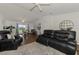 Open living room area features modern furniture, wood floors, and access to the dining room and kitchen at 149 Sportsman Rd, Rotonda West, FL 33947