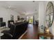 This cozy living room is bright and airy, with hardwood floors, ceiling fans, and modern furnishings at 149 Sportsman Rd, Rotonda West, FL 33947