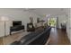 This spacious living room features a ceiling fan, hardwood floors, and sliding doors to the backyard at 149 Sportsman Rd, Rotonda West, FL 33947