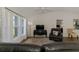 Cozy living room with bright, natural light, a ceiling fan, and a decorative rug for added appeal at 149 Sportsman Rd, Rotonda West, FL 33947