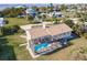 Aerial view of home with screened in pool, lush backyard and surrounding community at 156 Danforth Dr, Punta Gorda, FL 33980