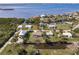 An aerial view of a waterfront home with a screened-in pool at 156 Danforth Dr, Punta Gorda, FL 33980