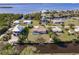 Aerial view showcases waterfront home, pool, boat dock, and surrounding natural beauty at 156 Danforth Dr, Punta Gorda, FL 33980
