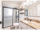 Modern bathroom featuring a glass-enclosed shower and sleek vanity with stone countertop at 156 Danforth Dr, Punta Gorda, FL 33980