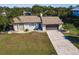 Aerial view of a home with a two car garage and long driveway at 156 Danforth Dr, Punta Gorda, FL 33980