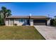 Charming single-story home featuring a stone accent wall, well-manicured lawn and attached two-car garage at 156 Danforth Dr, Punta Gorda, FL 33980