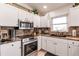 Updated kitchen showcases stainless steel appliances, granite countertops, and sleek cabinetry at 156 Danforth Dr, Punta Gorda, FL 33980