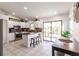 Bright, open kitchen with white cabinets, granite counters, stainless appliances, and outdoor access at 156 Danforth Dr, Punta Gorda, FL 33980