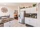 The kitchen features white cabinets, stainless steel fridge, and seamless flow into the cozy living room at 156 Danforth Dr, Punta Gorda, FL 33980