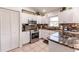 Well-appointed kitchen with stainless steel oven and microwave, granite countertops, and white cabinetry at 156 Danforth Dr, Punta Gorda, FL 33980