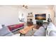 Spacious living room showcases a brick fireplace, hardwood floors, and seamless flow to the dining area at 156 Danforth Dr, Punta Gorda, FL 33980