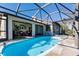 Enclosed pool area featuring a clean pool, stone pavers, and easy access to indoor living at 156 Danforth Dr, Punta Gorda, FL 33980