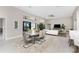 Bright dining area with modern table, seamlessly flowing into the living area and offering backyard views at 16210 Cape Horn Blvd, Punta Gorda, FL 33955