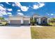 Contemporary home with a manicured lawn, two-car garage, and a modern design aesthetic at 16210 Cape Horn Blvd, Punta Gorda, FL 33955
