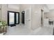 Bright foyer with frosted double doors, tile flooring, and convenient mirror at 16210 Cape Horn Blvd, Punta Gorda, FL 33955
