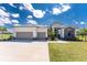 Beautiful single-story home boasts a three-car garage and modern architectural details and landscaped front yard at 16210 Cape Horn Blvd, Punta Gorda, FL 33955