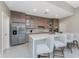 Modern kitchen features quartz countertops, breakfast bar, wood cabinets, and stainless steel appliances at 16210 Cape Horn Blvd, Punta Gorda, FL 33955