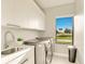 Efficient laundry room with sleek cabinetry, modern appliances, and ample natural light at 16210 Cape Horn Blvd, Punta Gorda, FL 33955