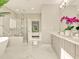 Elegant main bathroom featuring a modern soaking tub, walk-in shower, and dual vanity at 16210 Cape Horn Blvd, Punta Gorda, FL 33955