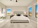 Bright main bedroom featuring neutral tones, a large window view, and a ceiling fan at 16210 Cape Horn Blvd, Punta Gorda, FL 33955