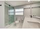 Updated bathroom featuring a glass-enclosed shower, white tile floor, and a double sink vanity at 165 Cummins Ne Ave, Port Charlotte, FL 33952