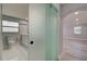 Modern bathroom featuring new fixtures, a glass shower door, and a tile floor at 165 Cummins Ne Ave, Port Charlotte, FL 33952